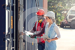 Businesswoman and engineer talking and checking loading Containers box from Cargo freight ship for import export. shipping in