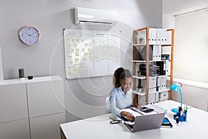 Businesswoman Enjoying The Cooling Of Air Conditioner