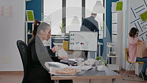 Businesswoman enjoying food meal order in company office during takeout lunchtime break