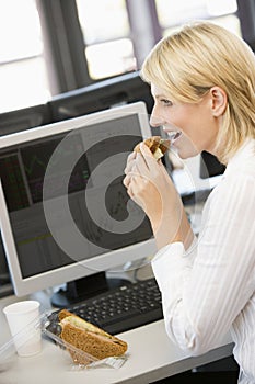 Businesswoman Enjoying Sandwich During Lunchbreak