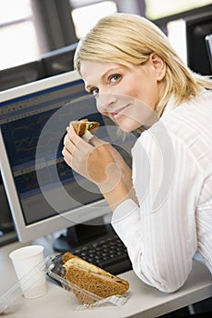 Businesswoman Enjoying Sandwich During Lunchbreak