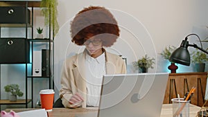 Businesswoman enters office start working on laptop computer at desk and drinking morning coffee