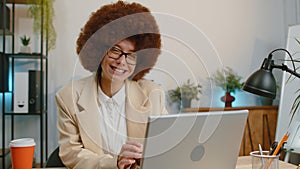 Businesswoman enters office start working on laptop computer at desk and drinking morning coffee