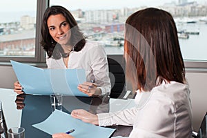 Businesswoman evaluating the performance of a worker