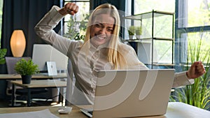 Businesswoman excited woman girl female winner working with laptop celebrate computer win online business success in