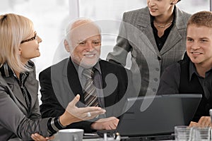 Businesswoman explaining work to colleagues