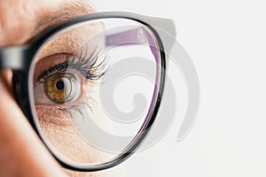 Businesswoman eye with glasses close-up