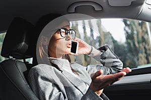 Businesswoman in eyeglasses gesturing while talking