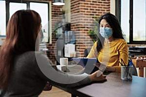 Businesswoman with face mask interviewing potential manager