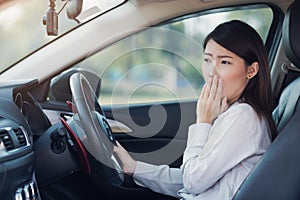 Businesswoman feel tried and sleepy in a car