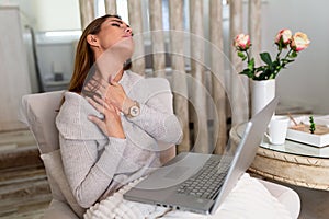 Businesswoman feeling pain in neck after sitting at the table with laptop. Tired female suffering of office syndrome because of