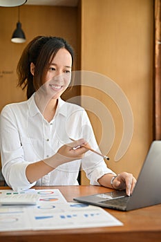 Businesswoman or female financial analysts working at her office desk