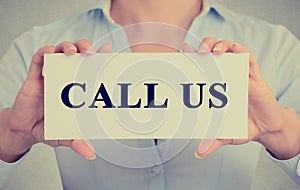 Businesswoman, female hands holding white sign with message call us