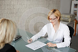 Businesswoman fill out a form in office