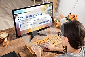 Woman Filling The Car Insurance Form On Computer