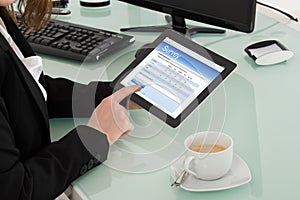 Businesswoman Filling Online Survey Form On Digital Tablet