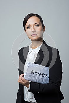 Businesswoman with financial newspaper