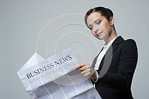 Businesswoman with financial newspaper