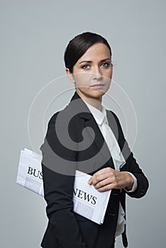 Businesswoman with financial newspaper