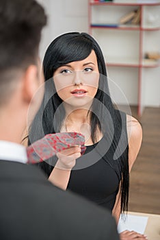 Businesswoman flirting and pulling her colleague