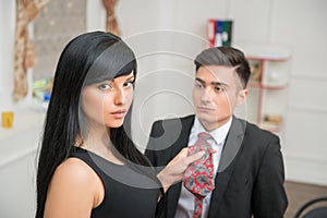 Businesswoman flirting and pulling her colleague