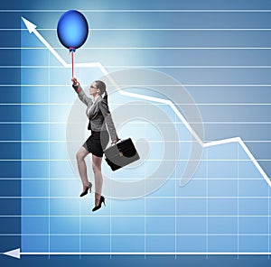 Businesswoman flying on hot balloon over graph