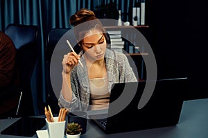 Businesswoman focusing computer with coworker working at back side. Infobahn.