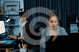 Businesswoman focusing computer with coworker working at back side. Infobahn.