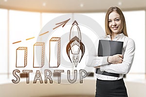 Businesswoman with folder and start up