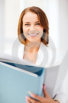 Businesswoman with folders in office photo