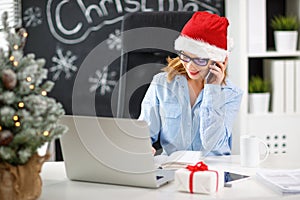 Businesswoman freelancer working at a computer at Christmas