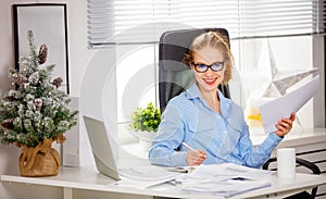 Businesswoman freelancer working at a computer at Christmas