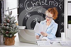 Businesswoman freelancer working at a computer at Christmas