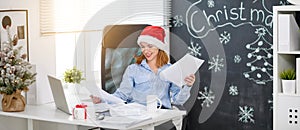 Businesswoman freelancer working at a computer at Christmas photo