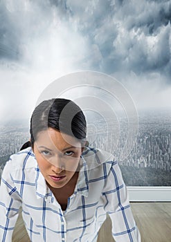 Businesswoman in front of city with determined face