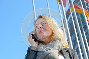 Businesswoman in front of national flags