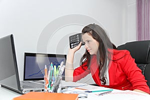 Businesswoman frustated with work, has a lot of work at the office