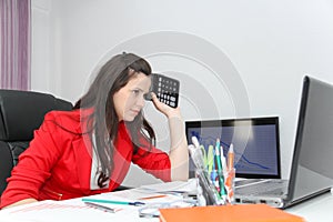 Businesswoman frustated with work, has a lot of work at the office