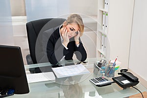 Businesswoman with gantt progress chart at desk