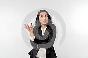 Businesswoman gesturing hand while looking dejected in the camera, standing over white background. Small business owners, women