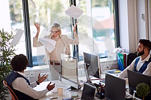 Businesswoman getting angry at a coworker. Businesswoman throwing the papers in rage