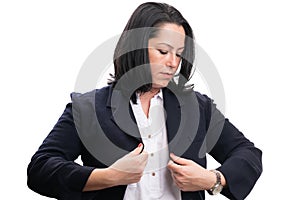 Businesswoman getting ready for work arranging suit