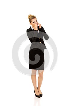 Businesswoman giggles covering her mouth with hand