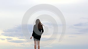 Businesswoman girl female student standing on beach with arms raised