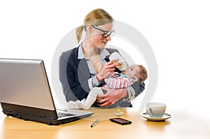 Businesswoman gives baby the bottle photo