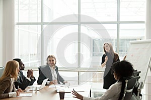 Businesswoman giving presentation for multiracial corporate team