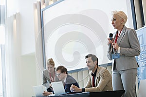 Businesswoman giving presentation in seminar hall