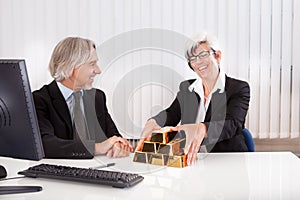 Businesswoman with gold bullion bars