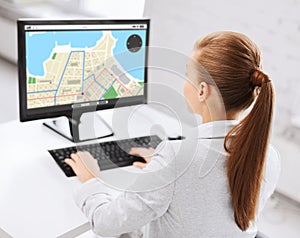 Businesswoman with gps navigator map on computer