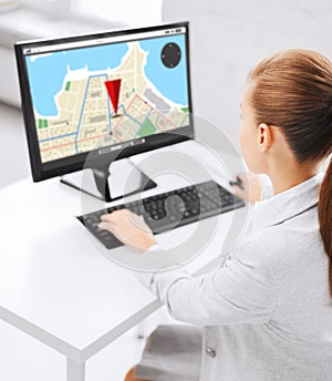 Businesswoman with gps navigator map on computer